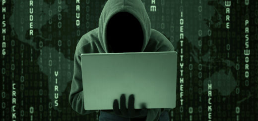 Hoodie hacker behind a laptop